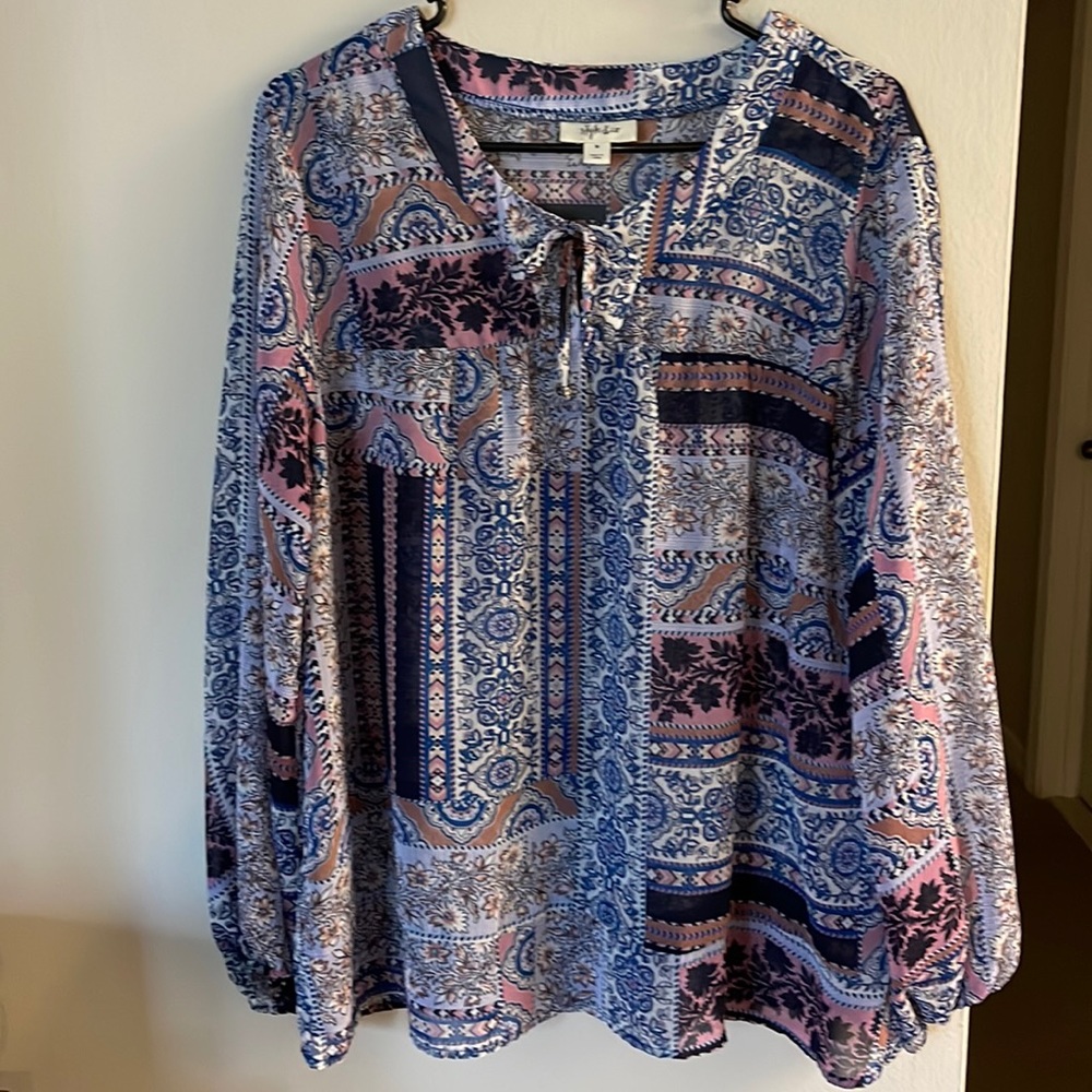 Gorgeous sheer medium top. This blue and pink top is perfect for work or play.